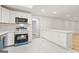 Well-lit kitchen with white cabinetry, island seating, and new appliances at 2544 Overlook Dr, East Point, GA 30344