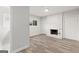 Neutral living room with light gray walls, wood-look floors, white brick fireplace, and window at 2544 Overlook Dr, East Point, GA 30344