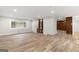 Large living room featuring hardwood flooring, a built-in bookshelf, and ample light at 2544 Overlook Dr, East Point, GA 30344