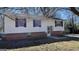 Exterior view of a raised ranch home with white siding, black shutters and a brick foundation at 893 Boca Raton Dr, Forest Park, GA 30297