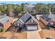 An aerial view of a well-maintained home with a manicured lawn, surrounded by lush greenery and neighboring houses at 509 Carleton Pl, Locust Grove, GA 30248