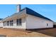 Back exterior with neutral siding and visible landscaping at 509 Carleton Pl, Locust Grove, GA 30248