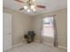 Comfortable bedroom featuring neutral carpet and walls, a ceiling fan and a lovely window at 509 Carleton Pl, Locust Grove, GA 30248