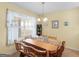 Dining area with a wooden table, bench seating, and a window overlooking the backyard at 509 Carleton Pl, Locust Grove, GA 30248