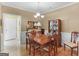 Elegant dining room with chandelier, wainscotting, and a wood dining set with china cabinet at 509 Carleton Pl, Locust Grove, GA 30248