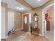 Bright foyer with hardwood floors, a charming mirror table, and a view of the front door at 509 Carleton Pl, Locust Grove, GA 30248