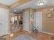 Hallway view highlighting hardwood floors, neutral-colored walls, and access to multiple rooms at 509 Carleton Pl, Locust Grove, GA 30248