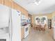 Bright kitchen featuring white appliances, light wood cabinets, and an adjacent dining area at 509 Carleton Pl, Locust Grove, GA 30248