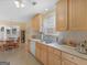 Traditional kitchen with light wood cabinets, tile countertops, and a bright, open dining area at 509 Carleton Pl, Locust Grove, GA 30248