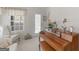Sunlit piano room with window and door access, enhanced by a comfortable chair at 509 Carleton Pl, Locust Grove, GA 30248