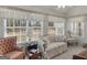 Bright sun room features large windows, stylish drapery, and comfortable seating at 509 Carleton Pl, Locust Grove, GA 30248