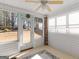 Sunroom featuring multiple windows, white paneling, carpet, and ceiling fan at 509 Carleton Pl, Locust Grove, GA 30248