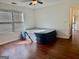 A spacious bedroom featuring hardwood floors and a large window with blinds for natural light at 19201 Waldrop Cv, Decatur, GA 30034