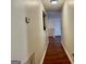 Hallway with dark wood floors leading to a white door at 19201 Waldrop Cv, Decatur, GA 30034