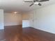 Spacious living room featuring wood floors, ceiling fan, and a white door at 19201 Waldrop Cv, Decatur, GA 30034