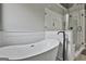 View of a bathtub and shower with a white marble surround in a luxurious bathroom at 285 Hogan Coweta Rd, Hogansville, GA 30230