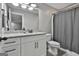 Bathroom features a new vanity with stone countertops, a large mirror, and a shower with gray tiling at 285 Hogan Coweta Rd, Hogansville, GA 30230
