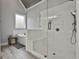 A bathroom featuring a glass-enclosed shower, soaking tub, wood-look floors and a built-in wall niche at 285 Hogan Coweta Rd, Hogansville, GA 30230