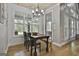 Bright dining area featuring wood floors, modern light fixture, and views to the outside at 285 Hogan Coweta Rd, Hogansville, GA 30230
