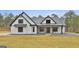 Stunning modern farmhouse with black accents, a manicured lawn, and a welcoming front porch at 285 Hogan Coweta Rd, Hogansville, GA 30230