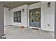 Covered entryway with grey double doors, fall decor, and a stylish 'home' welcome mat at 285 Hogan Coweta Rd, Hogansville, GA 30230