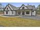 Inviting farmhouse style home with black trimmed windows, gravel landscaping, and covered porch at 285 Hogan Coweta Rd, Hogansville, GA 30230