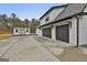 Side view of farmhouse featuring a 3-car garage, storage shed, and a concrete driveway at 285 Hogan Coweta Rd, Hogansville, GA 30230