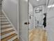 Hallway with light wood floors, a staircase, and a view of the laundry room at 285 Hogan Coweta Rd, Hogansville, GA 30230