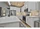 Bright white kitchen with stainless steel appliances, modern countertops, and hardwood floors at 285 Hogan Coweta Rd, Hogansville, GA 30230