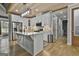 Bright white kitchen with stainless steel appliances, wooden floors, island and wood paneled ceiling at 285 Hogan Coweta Rd, Hogansville, GA 30230