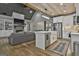 Open-concept kitchen and living area with fireplace, stainless steel appliances, and a cozy sofa at 285 Hogan Coweta Rd, Hogansville, GA 30230