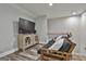 Comfortable living space features hardwood floors, a TV and console, and a futon near the staircase at 285 Hogan Coweta Rd, Hogansville, GA 30230