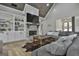 Vaulted living room with stone fireplace and large windows, flowing to other living spaces at 285 Hogan Coweta Rd, Hogansville, GA 30230