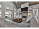 Bright living room with stone fireplace, built-in shelves and a large sectional sofa at 285 Hogan Coweta Rd, Hogansville, GA 30230