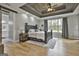 This main bedroom features a wood tray ceiling, recessed lights, and a large window with views of the yard at 285 Hogan Coweta Rd, Hogansville, GA 30230