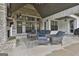 Inviting covered patio with stone fireplace and comfortable wicker furniture at 285 Hogan Coweta Rd, Hogansville, GA 30230