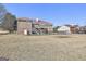 Expansive backyard featuring a brick house with a balcony and a fenced area, perfect for outdoor activities at 205 Castlewood Rd, Tyrone, GA 30290