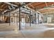 Unfinished basement space with high ceilings and exposed beams offers potential for customization and storage at 205 Castlewood Rd, Tyrone, GA 30290