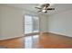 An open bedroom with hardwood floors, a ceiling fan, and a window that provides natural light at 205 Castlewood Rd, Tyrone, GA 30290