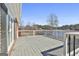 View of a grey stained deck overlooking the lake, surrounded by a white wood railing at 205 Castlewood Rd, Tyrone, GA 30290
