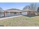 Charming brick home with white pergola, covered porch and nicely manicured lawn at 205 Castlewood Rd, Tyrone, GA 30290