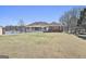 Inviting front exterior featuring a brick facade, well-manicured lawn, and waterfront view at 205 Castlewood Rd, Tyrone, GA 30290