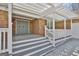 Welcoming front porch with double doors, classic brickwork, and stylish white pergola at 205 Castlewood Rd, Tyrone, GA 30290