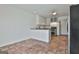 Kitchen with brick floors, stainless steel oven, white cabinets, and ample counter space at 205 Castlewood Rd, Tyrone, GA 30290