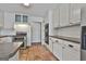 Charming kitchen features stainless steel appliances, granite countertops, and white cabinets at 205 Castlewood Rd, Tyrone, GA 30290