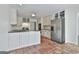 Bright kitchen with stainless steel appliances, tile floors, and white cabinetry at 205 Castlewood Rd, Tyrone, GA 30290