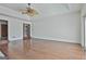 Bright living room featuring wood floors, ceiling fan, and sliding glass doors to a large window at 205 Castlewood Rd, Tyrone, GA 30290