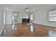 Bright living room with wood flooring, ceiling fan, and an entry to a bathroom at 205 Castlewood Rd, Tyrone, GA 30290