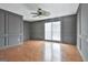 Living room with natural lighting, wood floors, and decorative wood wall trim at 205 Castlewood Rd, Tyrone, GA 30290