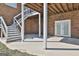 Covered patio area with stairs and access to the backyard, perfect for outdoor relaxation and entertainment at 205 Castlewood Rd, Tyrone, GA 30290